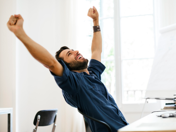 Man at computer, celebrating career