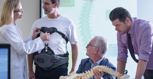 A doctor fitting a patient with a medical device